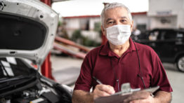 Portrait Of Auto Mechanic Senior Man With Face Mask At Auto Repair Shop